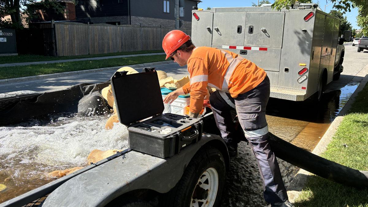 City staff person testing water after watermain swabbing