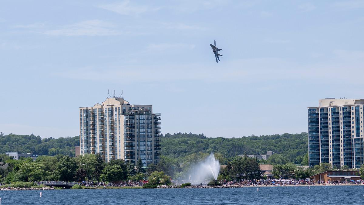 CF-18 flying over the Barrie waterfront in front of a large crowd