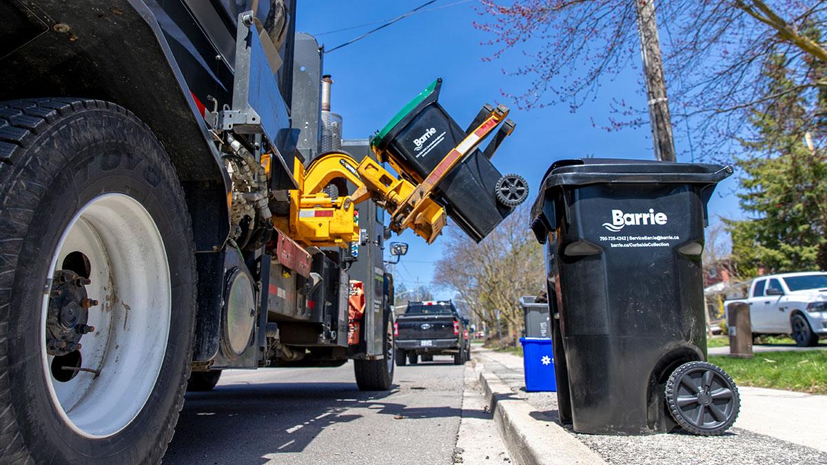 Curbside cart being picked up by automated arm of truck