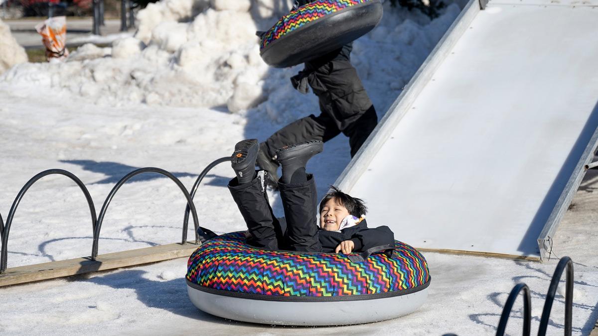 Kid tubing on a slide