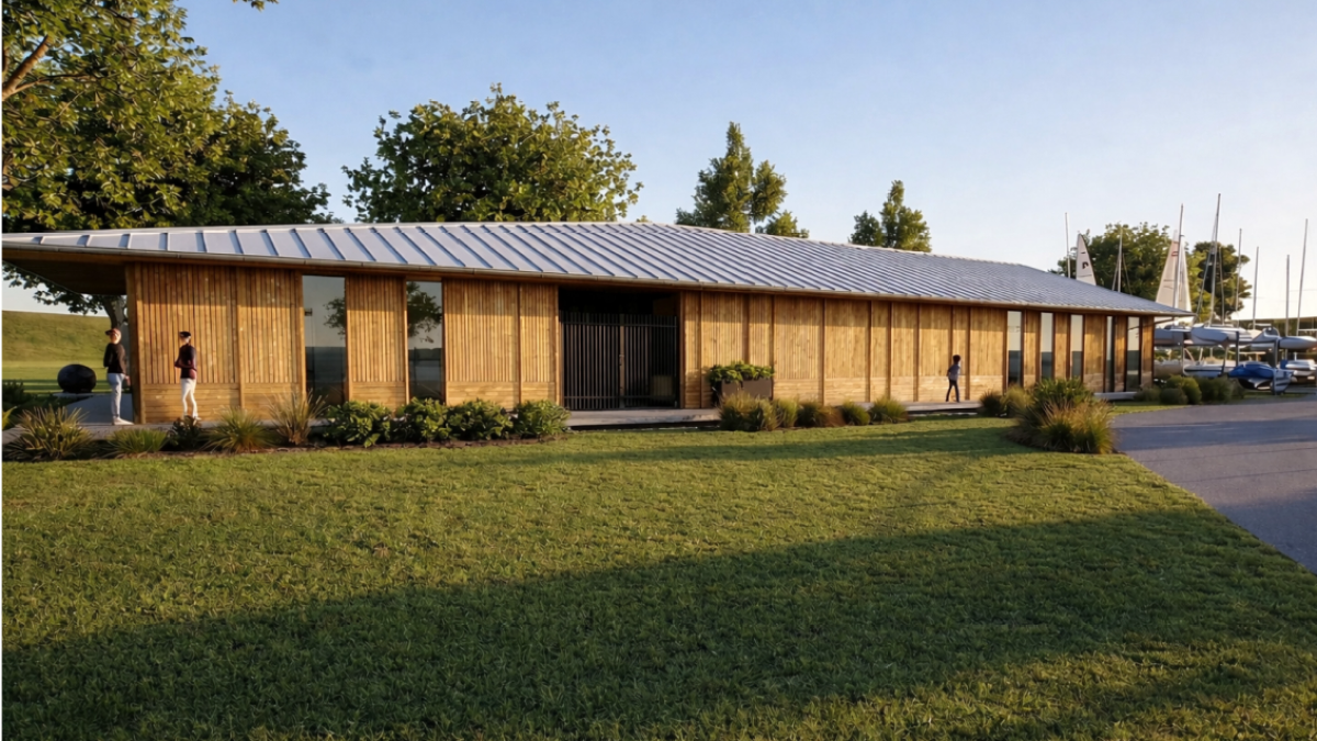 Modern wooden building, surrounded by grass and trees.